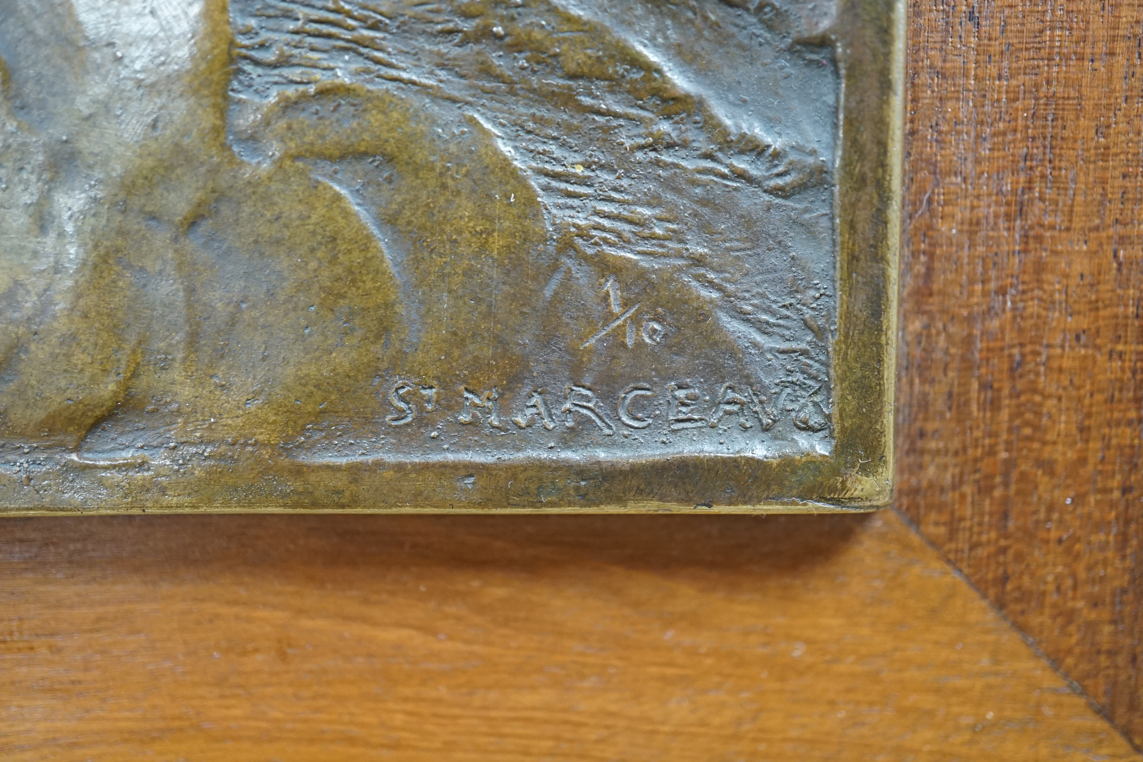 A framed bronze plaque of a kneeling figure, signed lower right, St. Marceau, limited edition 1/10, 31cm high. Condition - good